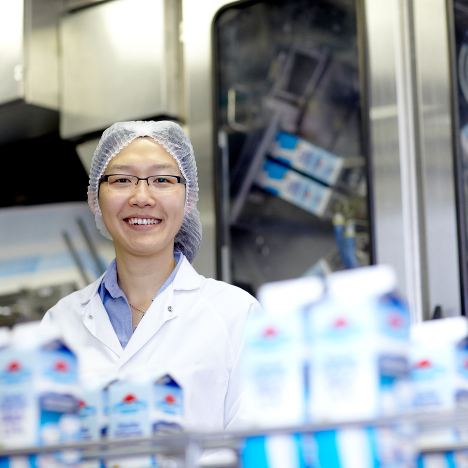 Women standing in a dairy processing plant