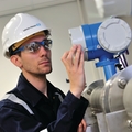 Service technician performing maintenance on process instrumentation