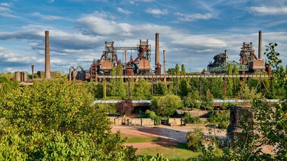 Steel plant in the middle of a green landscape.